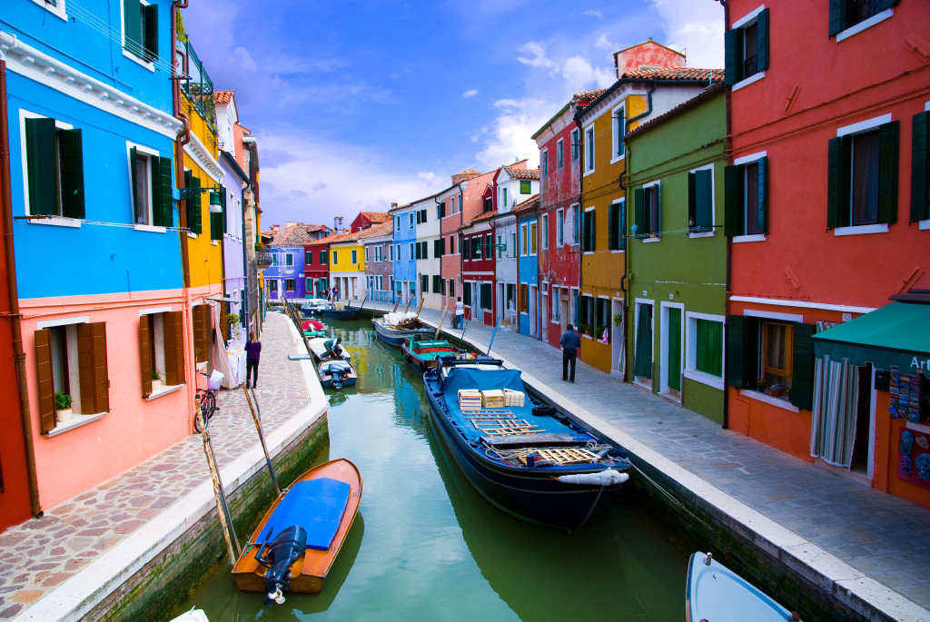 Venice, Burano island canal, small colored houses and the boats